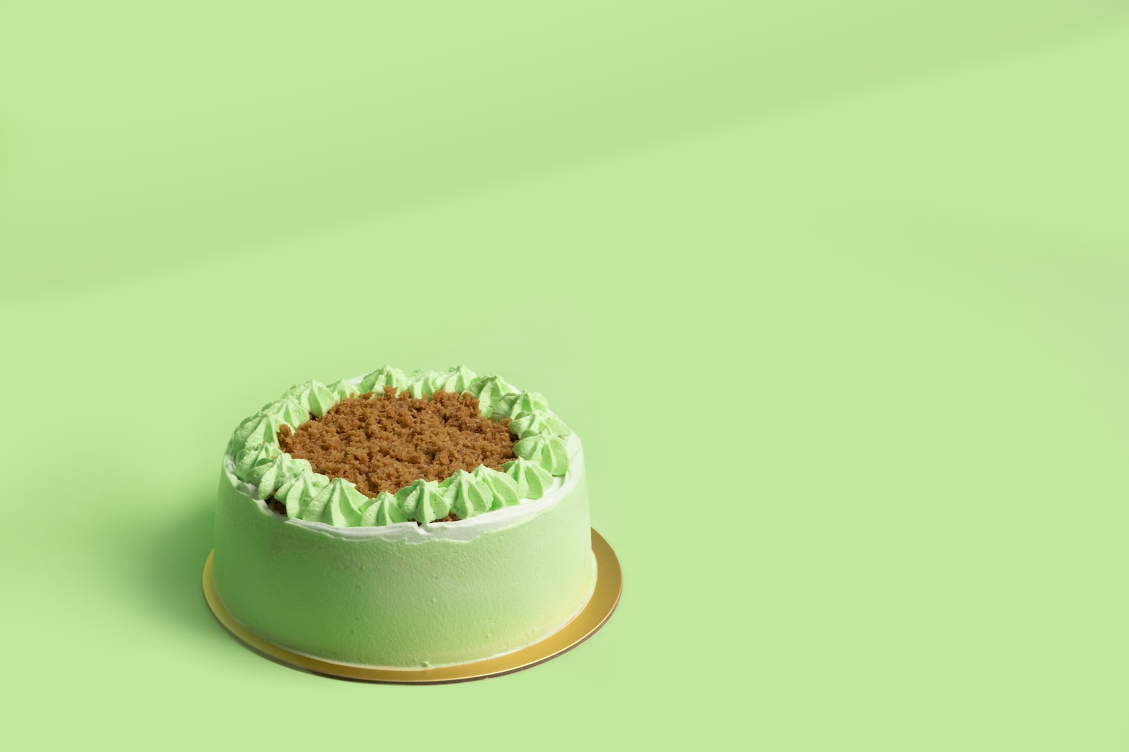 green and white cake on green round plate